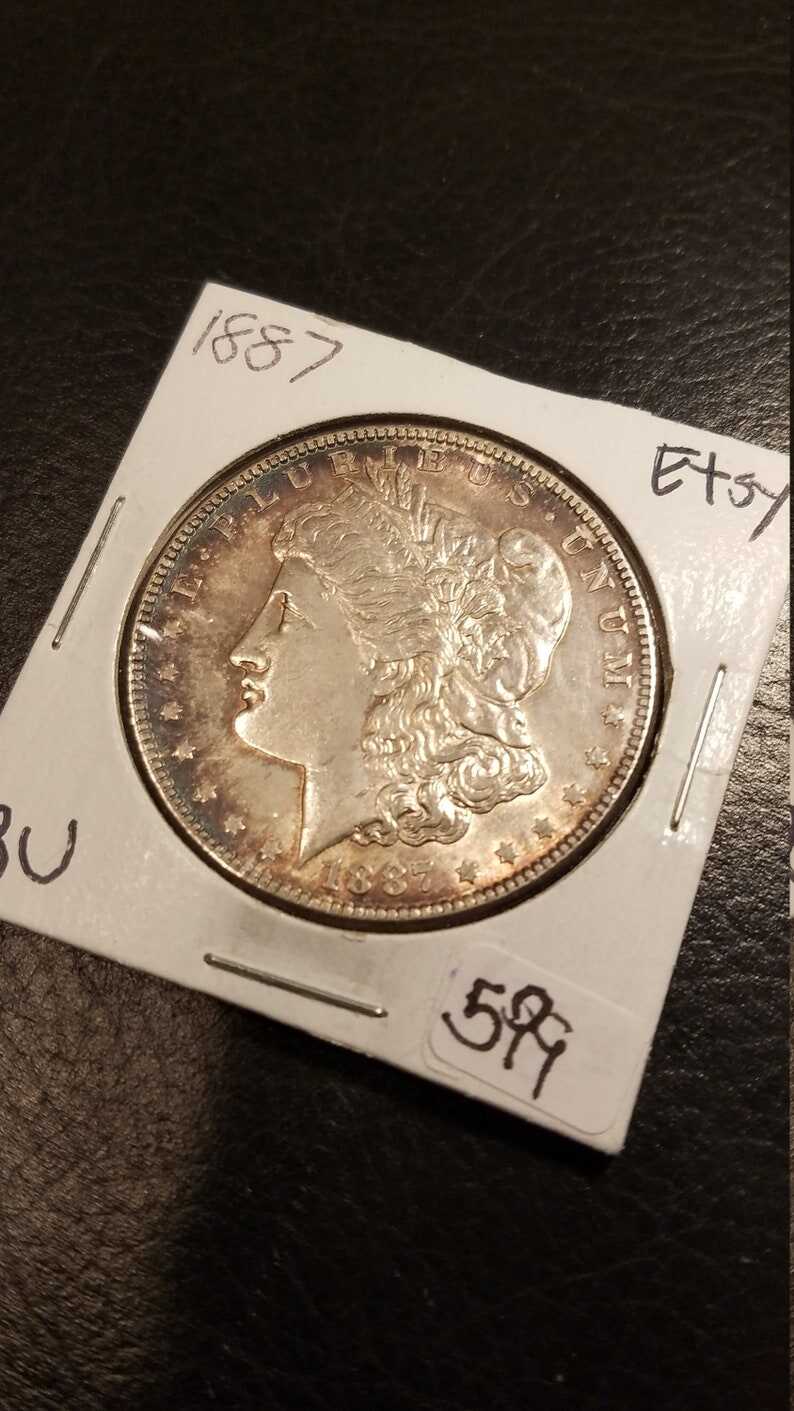 1887 Morgan Silver Dollar BU - nice toning! . Lot#599 Regular 105
