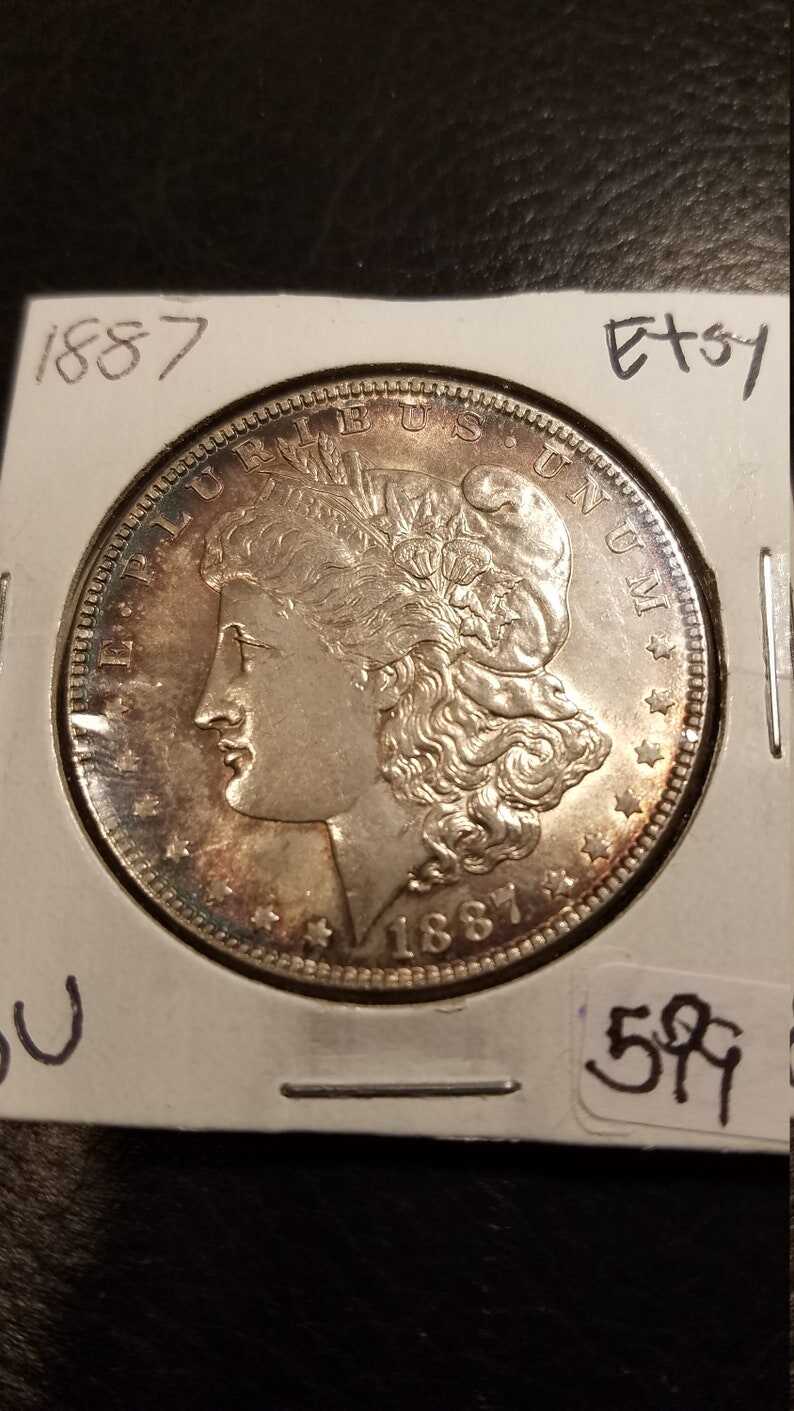 1887 Morgan Silver Dollar BU - nice toning! . Lot#599 Regular 105