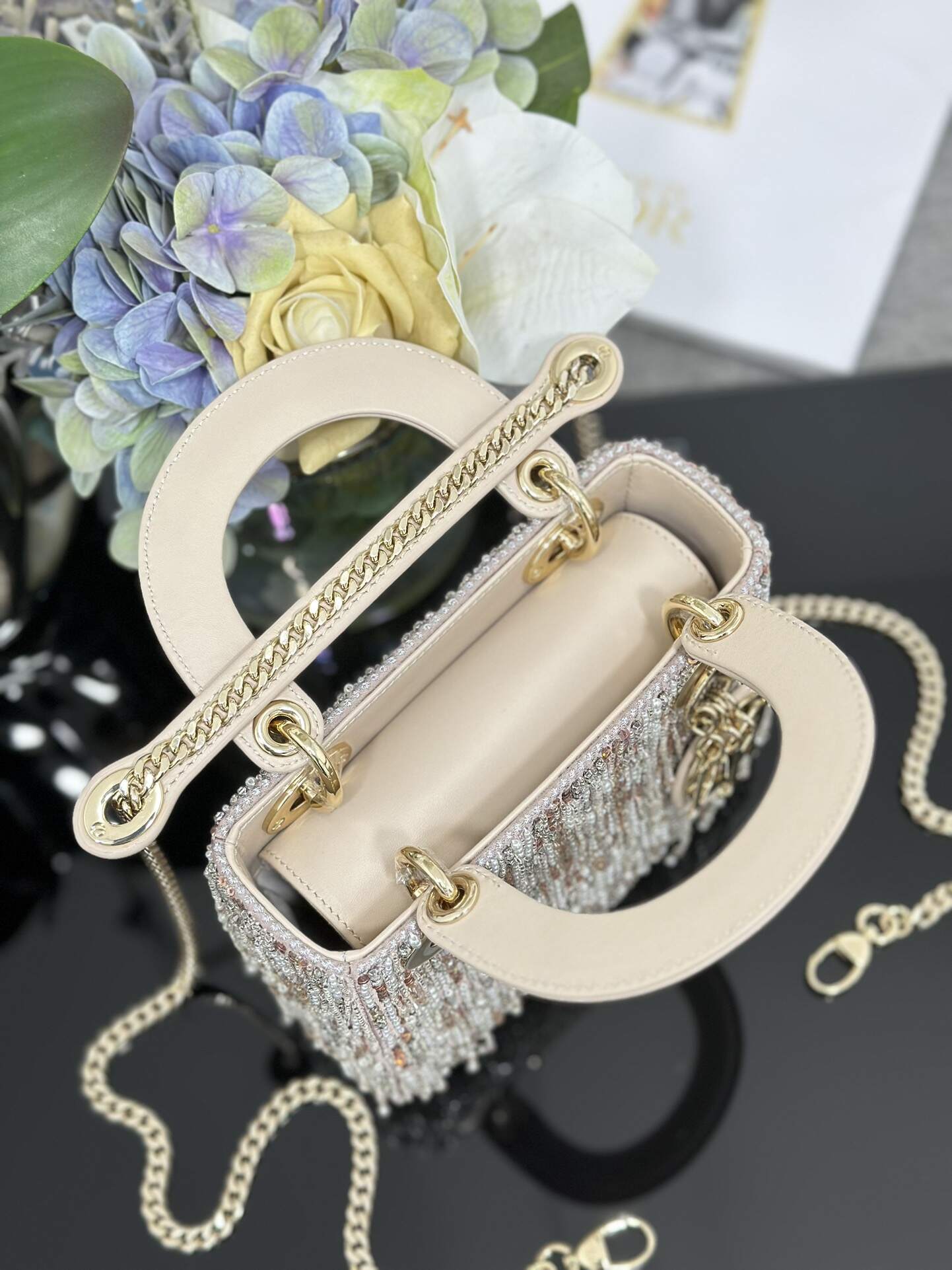 The Lady Dior Three-Grid Embroidered Fringe Beaded bag features an interior lined with lambskin