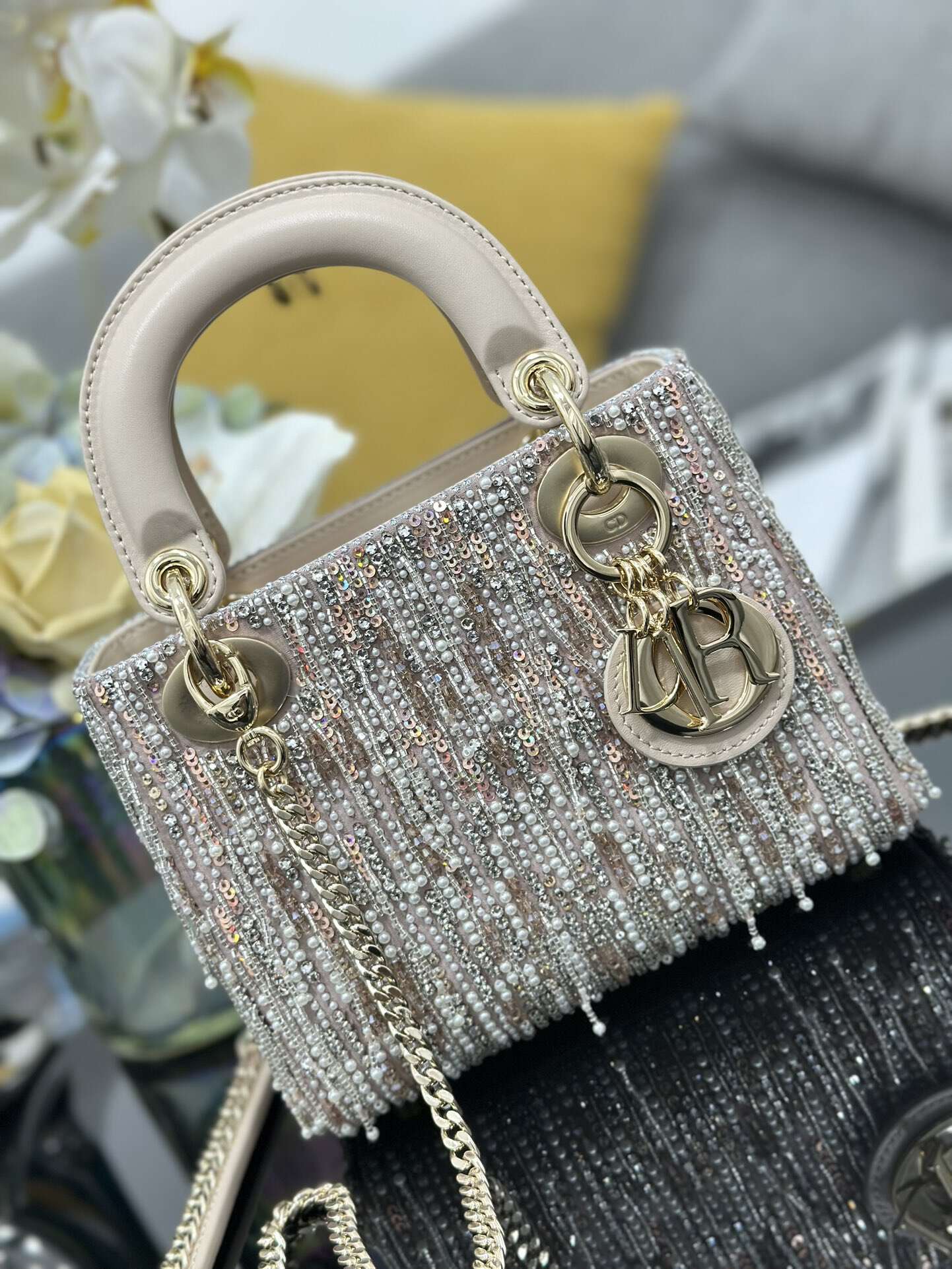 The Lady Dior Three-Grid Embroidered Fringe Beaded bag features an interior lined with lambskin