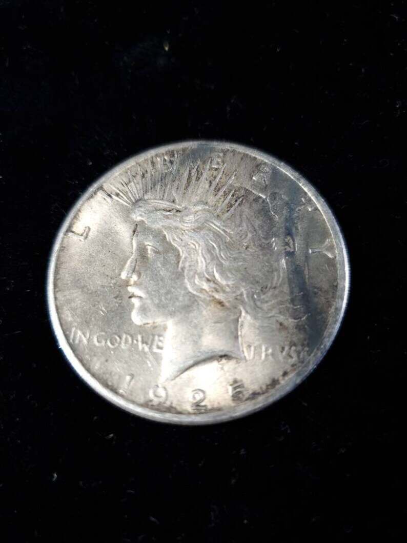 1925  Silver Peace Dollar AU - tarnish on obverse/reverse   Lot# 129