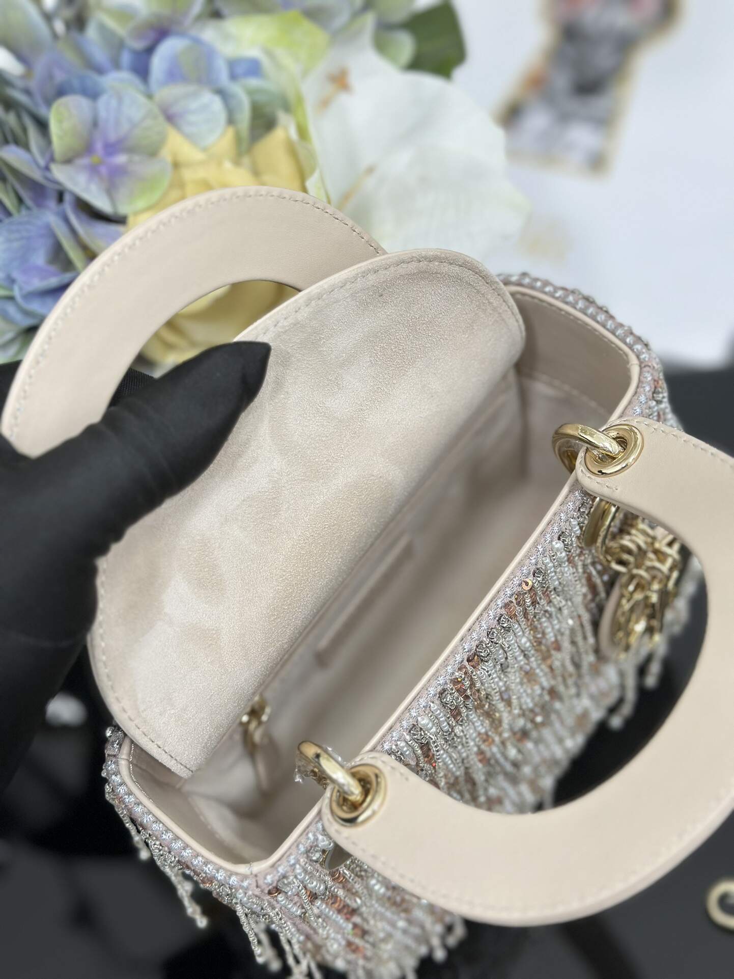 The Lady Dior Three-Grid Embroidered Fringe Beaded bag features an interior lined with lambskin