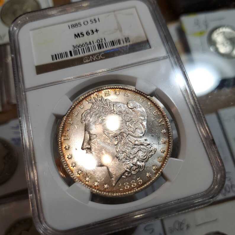 1885 O Morgan Silver Dollar, Nicely  Toned. NGC MS63+ lot#229